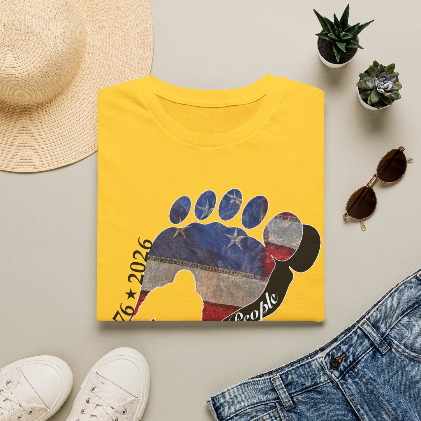 Going Norther Bigfoot T-Shirt — Footprint Silhouette with Distressed Flag & "1776 - 2026 - We The People"