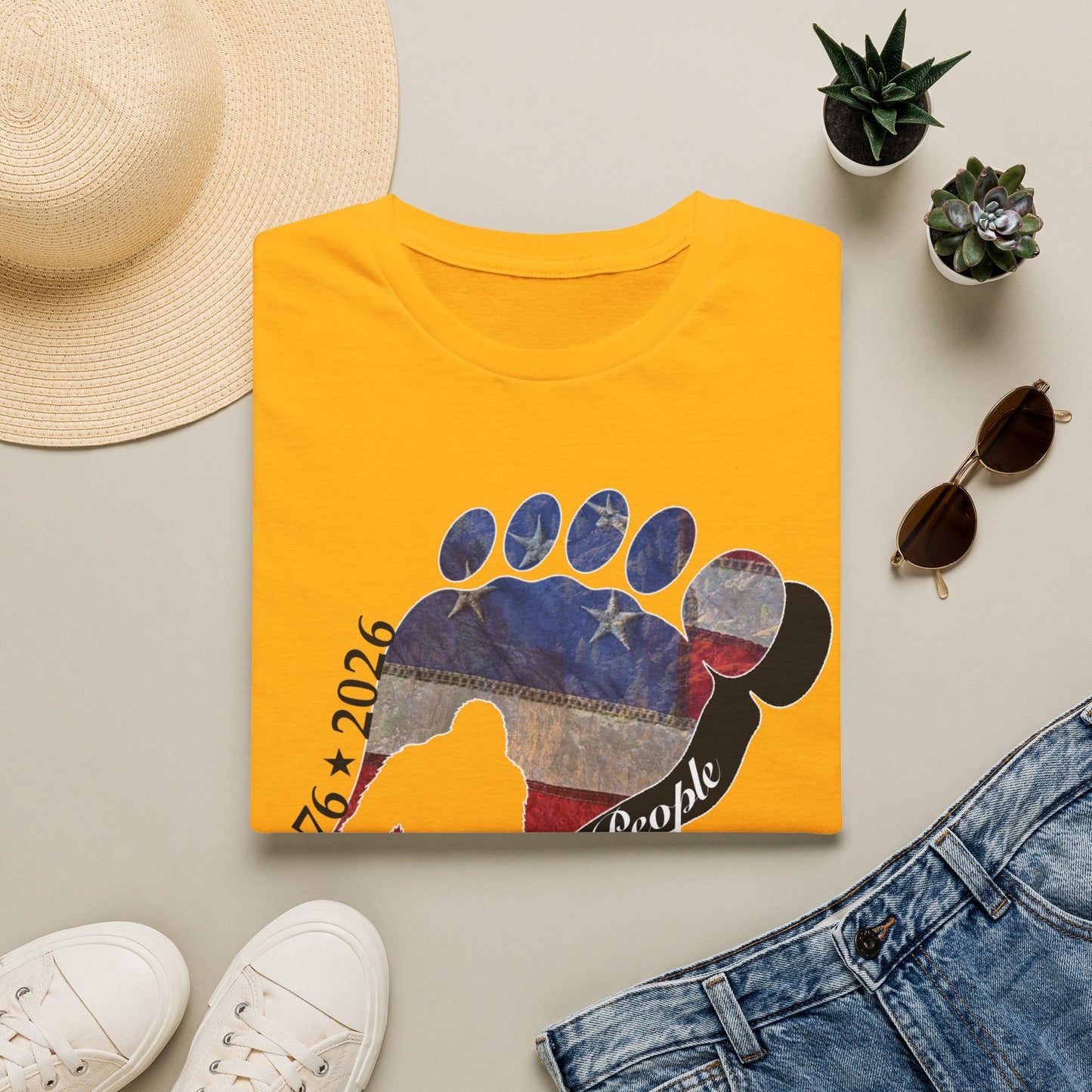 Going Norther Bigfoot T-Shirt — Footprint Silhouette with Distressed Flag & "1776 - 2026 - We The People"
