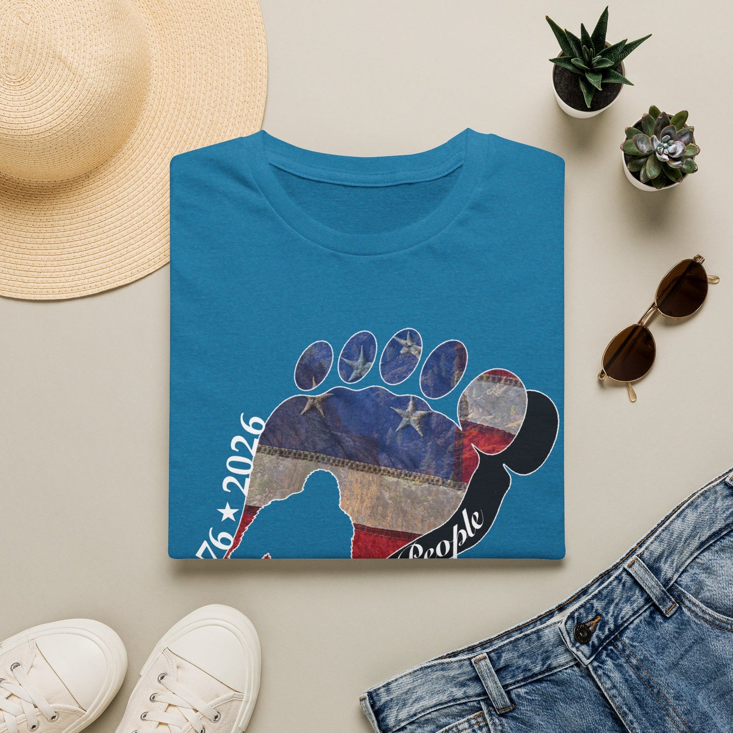 Going Norther Bigfoot T-Shirt — Footprint Silhouette with Distressed Flag & "1776 - 2026 - We The People"